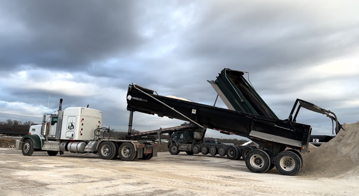 two end dumps with their beds extended