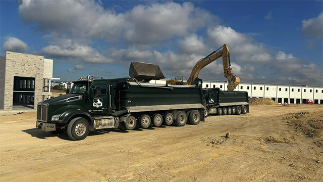 two super dumps being loaded with haul-off